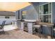 Outdoor kitchen complete with grill, beverage cooler, and bar seating for entertaining at 733 Old Windsor Way, Spring Hill, FL 34609