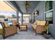 Relaxing covered patio with ample seating and view of the backyard pool at 733 Old Windsor Way, Spring Hill, FL 34609
