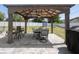 A charming outdoor covered dining area is equipped with a fan and grill at 733 Old Windsor Way, Spring Hill, FL 34609