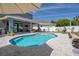Inviting backyard pool with covered patio, outdoor kitchen, and entertainment area at 733 Old Windsor Way, Spring Hill, FL 34609