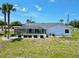 An outdoor space with pool, a large yard, and mature landscaping at 7538 Landmark Dr, Spring Hill, FL 34606