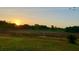 Beautiful landscape view with natural ponds and a golden sunrise in the background at 7538 Landmark Dr, Spring Hill, FL 34606