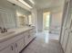 Spacious bathroom featuring a double sink vanity and a separate bath and toilet area at 7538 Landmark Dr, Spring Hill, FL 34606