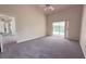 Bright bedroom featuring a ceiling fan and slider doors to the pool, offering a serene retreat at 7538 Landmark Dr, Spring Hill, FL 34606