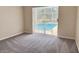 Bedroom with neutral carpet and a sliding glass door to pool at 7538 Landmark Dr, Spring Hill, FL 34606