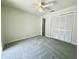 Bedroom boasts neutral carpet, ceiling fan, and closet doors at 7538 Landmark Dr, Spring Hill, FL 34606