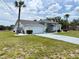 Charming single-story home featuring a two-car garage and well-manicured landscaping at 7538 Landmark Dr, Spring Hill, FL 34606