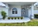 Inviting front porch of home with double entry doors, columns, and manicured landscaping at 7538 Landmark Dr, Spring Hill, FL 34606