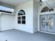 Inviting front porch of home with double entry doors, columns, and manicured landscaping at 7538 Landmark Dr, Spring Hill, FL 34606