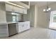 Spacious kitchen with tile flooring, white cabinetry and counter seating for casual dining at 7538 Landmark Dr, Spring Hill, FL 34606