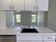 Bright kitchen featuring white cabinetry, stainless steel appliances, and an open view to the living area at 7538 Landmark Dr, Spring Hill, FL 34606