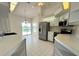 Bright kitchen featuring tile flooring, stainless steel appliances, and views of the pool area at 7538 Landmark Dr, Spring Hill, FL 34606
