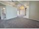 Spacious living room with neutral carpet and open layout to kitchen and other living areas at 7538 Landmark Dr, Spring Hill, FL 34606