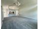 An expansive living room with neutral colors and seamless flow into the kitchen and other living spaces at 7538 Landmark Dr, Spring Hill, FL 34606