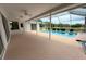 Covered pool deck for entertaining near the pool and lush backyard at 7538 Landmark Dr, Spring Hill, FL 34606