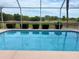 Screened in pool with lush greenery at 7538 Landmark Dr, Spring Hill, FL 34606