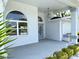 Welcoming front porch featuring tiled flooring, decorative windows, and a hanging light fixture at 7538 Landmark Dr, Spring Hill, FL 34606