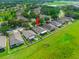 Overhead shot of the home with a well-maintained lawn, patio area, and neighborhood landscape at 779 Nodding Shade Dr, Brooksville, FL 34604