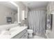 A bathroom offering a vanity with sink, decorative mirror, toilet, and tub with shower curtain at 779 Nodding Shade Dr, Brooksville, FL 34604