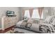 Bright bedroom with a comfortable bed, large dresser, and a television, creating a relaxing atmosphere at 779 Nodding Shade Dr, Brooksville, FL 34604