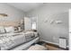 Neutral bedroom showcasing an open door to a bathroom and a stylish, patterned quilt on the bed at 779 Nodding Shade Dr, Brooksville, FL 34604