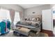 Cozy bedroom featuring a stylish black and white quilt, and bright natural light from the large windows at 779 Nodding Shade Dr, Brooksville, FL 34604