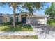 Charming single-story home with a two-car garage and mature landscaping at 779 Nodding Shade Dr, Brooksville, FL 34604