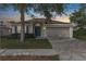 Charming single-story home with a two-car garage during sunset at 779 Nodding Shade Dr, Brooksville, FL 34604