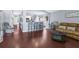 Open-concept living space with dark wood floors, barstool seating at the kitchen counter, and comfortable furnishings at 779 Nodding Shade Dr, Brooksville, FL 34604