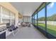 Spacious screened-in patio, featuring a seating area and grill, offers the perfect outdoor living space at 779 Nodding Shade Dr, Brooksville, FL 34604