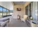 Well-lit screened-in patio with a seating area and mounted TV for outdoor enjoyment at 779 Nodding Shade Dr, Brooksville, FL 34604