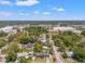 Neighborhood aerial showcasing the homes and trees in the surrounding community under a blue sky at 800 N Walton Ave, Tarpon Springs, FL 34689