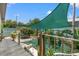 Backyard featuring a deck, gravel landscaping, privacy fence, and shade sail at 800 N Walton Ave, Tarpon Springs, FL 34689