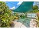 Backyard area featuring a sunshade and many plants at 800 N Walton Ave, Tarpon Springs, FL 34689