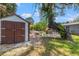 Backyard featuring a shed, patio, outdoor dining, and grill at 800 N Walton Ave, Tarpon Springs, FL 34689