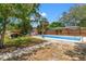 Backyard pool area with patio, grill, and privacy fence at 800 N Walton Ave, Tarpon Springs, FL 34689