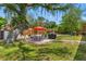 Expansive backyard with manicured lawn, patio, outdoor dining, and grill at 800 N Walton Ave, Tarpon Springs, FL 34689