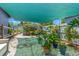 Backyard area featuring a sunshade, plants, and greenery at 800 N Walton Ave, Tarpon Springs, FL 34689