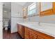 Bathroom features a double sink vanity with oak cabinets and tile flooring at 800 N Walton Ave, Tarpon Springs, FL 34689