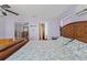 Bedroom featuring a large bed, hardwood floors, and pastel-colored walls at 800 N Walton Ave, Tarpon Springs, FL 34689