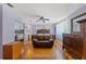 Spacious bedroom with light purple walls, wood flooring, and a ceiling fan at 800 N Walton Ave, Tarpon Springs, FL 34689