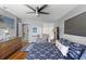 Well-lit bedroom featuring wood floors, a ceiling fan, and closet space at 800 N Walton Ave, Tarpon Springs, FL 34689