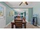 Dining room with wood floors and open doorway to the kitchen and a water cooler at 800 N Walton Ave, Tarpon Springs, FL 34689