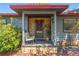 Inviting front porch with stone accents, seating, and a charming entrance at 800 N Walton Ave, Tarpon Springs, FL 34689