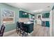 Bright kitchen with granite countertops, bar stool seating, and an exterior door at 800 N Walton Ave, Tarpon Springs, FL 34689