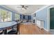 Cozy living room with a fireplace, hardwood floors, and large windows at 800 N Walton Ave, Tarpon Springs, FL 34689
