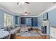 Spacious living room with hardwood floors, comfortable seating, and a view to a dining area at 800 N Walton Ave, Tarpon Springs, FL 34689