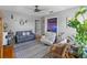 Cozy living room with gray walls, wood flooring, and plenty of plants at 800 N Walton Ave, Tarpon Springs, FL 34689