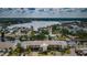 Aerial view of waterfront condo building located on a canal, with boat docks and parking at 8210 Aquila St # 218, Port Richey, FL 34668