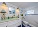 Nautical themed bathroom with a white vanity, blue accents and walk in shower at 8210 Aquila St # 218, Port Richey, FL 34668